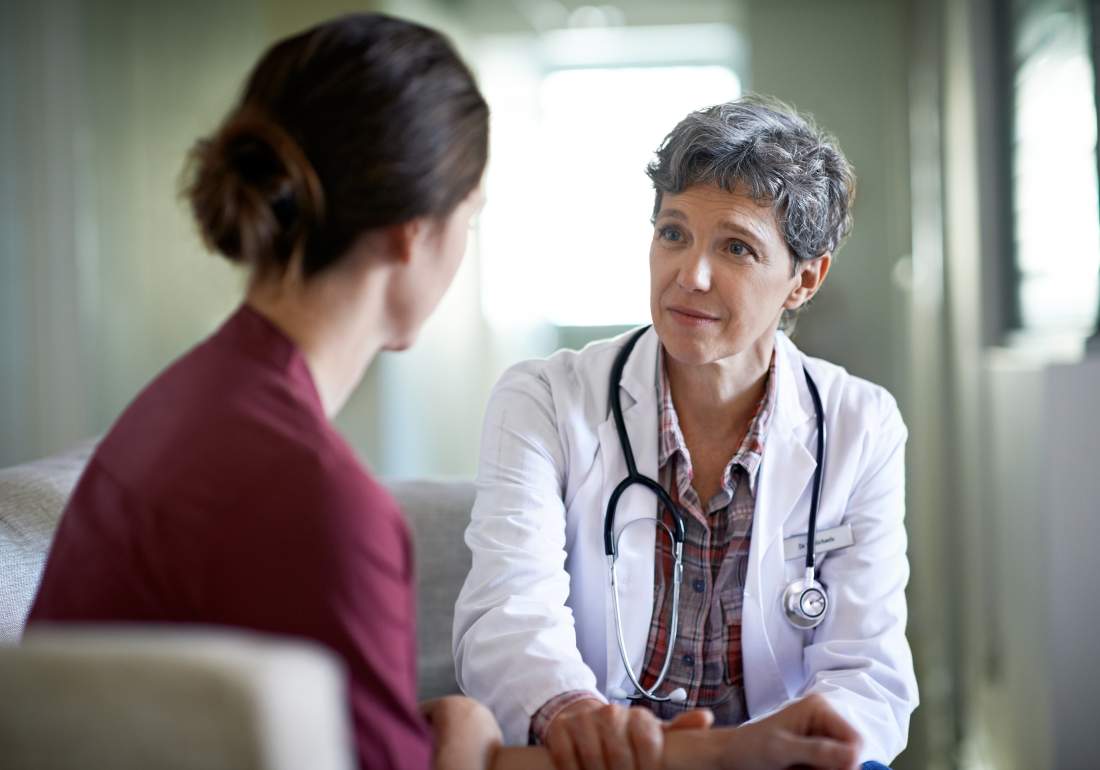 Female doctor comforting a female patient