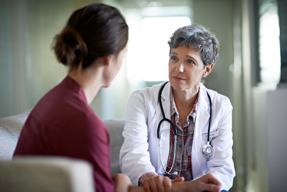 Female doctor comforting a female patient