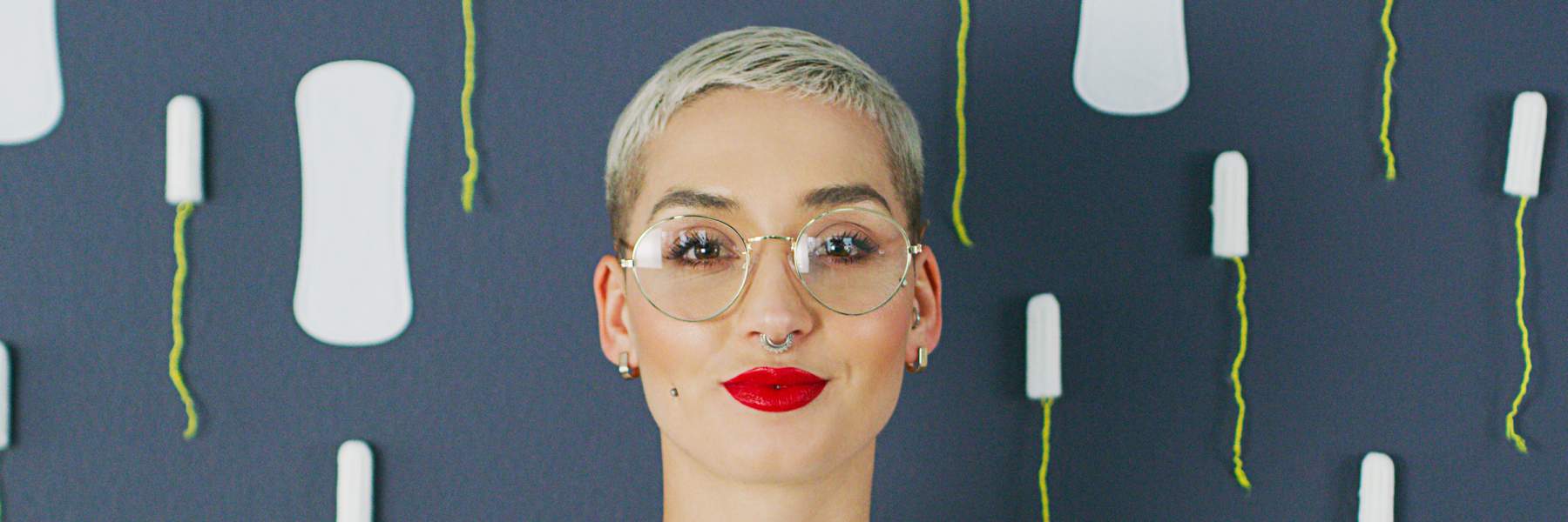 Woman stood with tampons and sanitary pads for endo symptoms