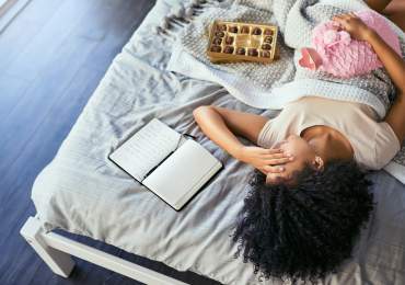Girl on bed struggling with endo period pain