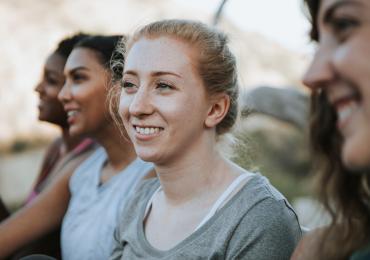 Young women listening and smiling