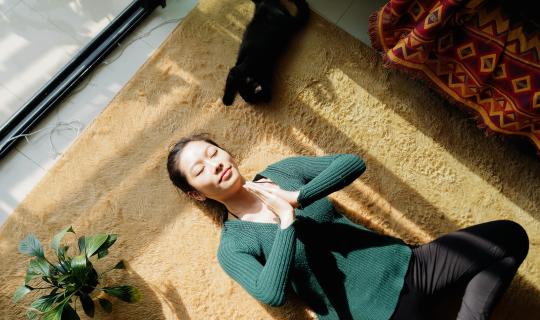 Woman meditating laying on floor