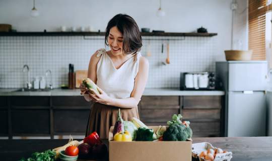 Woman looking at shopping preparing food for a healthy endo diet