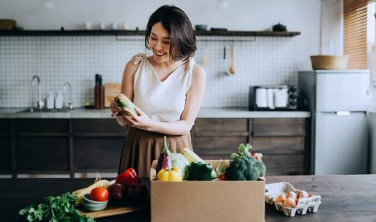 Woman looking at shopping preparing food for a healthy endo diet