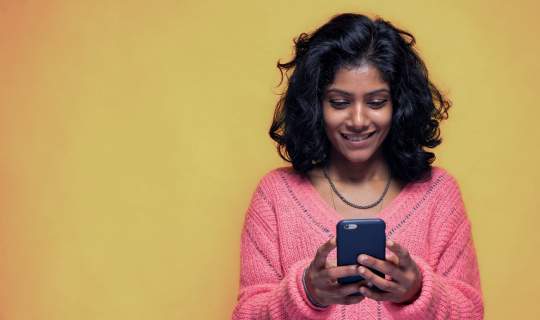 Young girl on phone looking for endo diagnosis