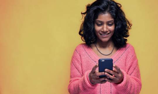 Young girl on phone looking for endo diagnosis
