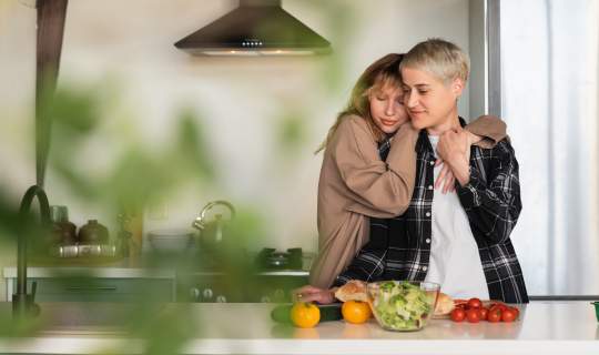 Couple cooking healthy salad food in kitchen